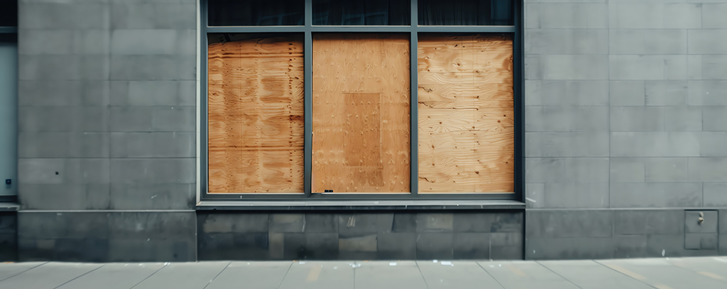 Property damage from break ins. Commercial store window board up.